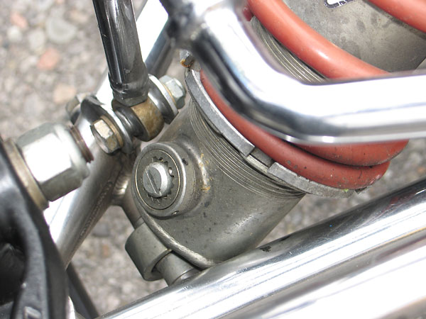 Compression adjuster at the bottom of the shock absorber.