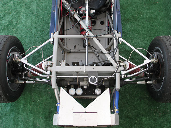 Airflow from the radiator core is diverted off to either side, and exits at suspension openings.