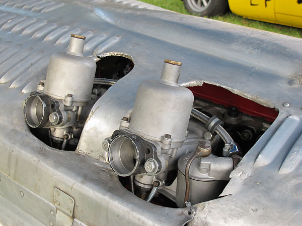 As originally raced, the carburetors didn't poke through the bonnet.