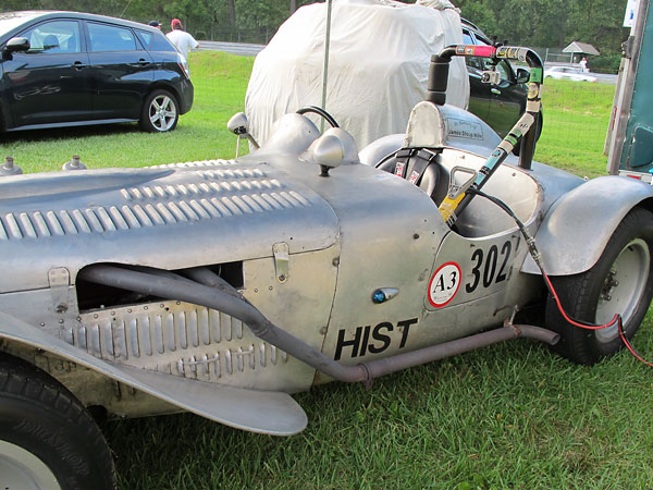 From the engine rearward, the exhaust pipe mounted on the driver's side of the car.