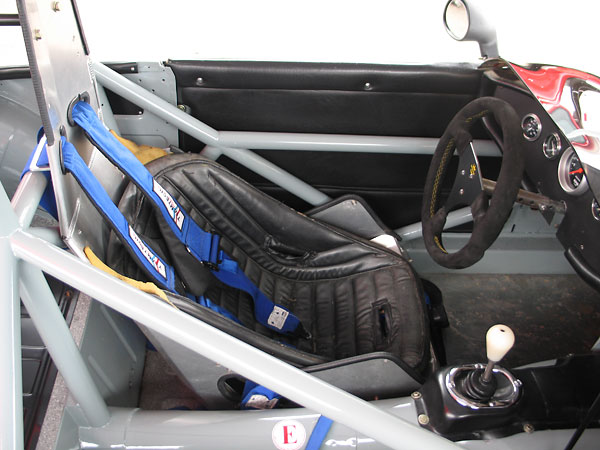 ButlerBuilt aluminum seat. Teamtech Motorsports Equipment safety harness.