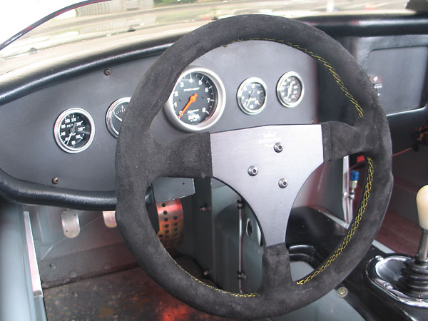 Personal anatomical, padded, black suede steering wheel.