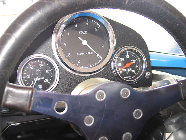 Stewart Warner oil pressure gauge, Stack tachometer, and AutoMeter water temperature gauge.