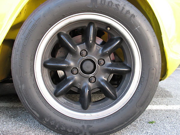 Panasport Racing 15 inch aluminum wheels.
