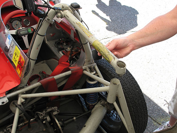 The rearward roll hoop brace ends at a cone and socket connection.