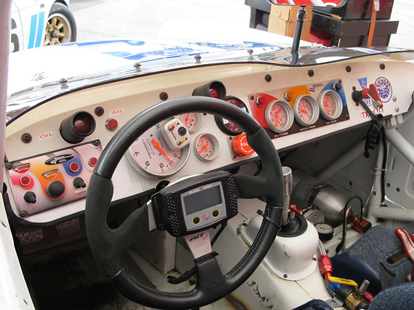 Overview of the instrument panel, shaded by a very low profile windscreen.