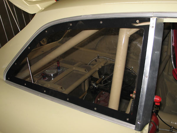 Aluminum spacers align the Lexan three-quarter windows with the door glass.