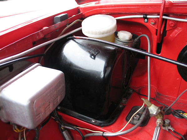 A later model MGB dual-circuit master cylinder has been installed.