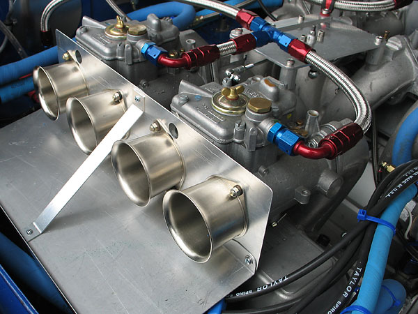 Stainless steel velocity stacks streamline airflow into the carburetor bores.