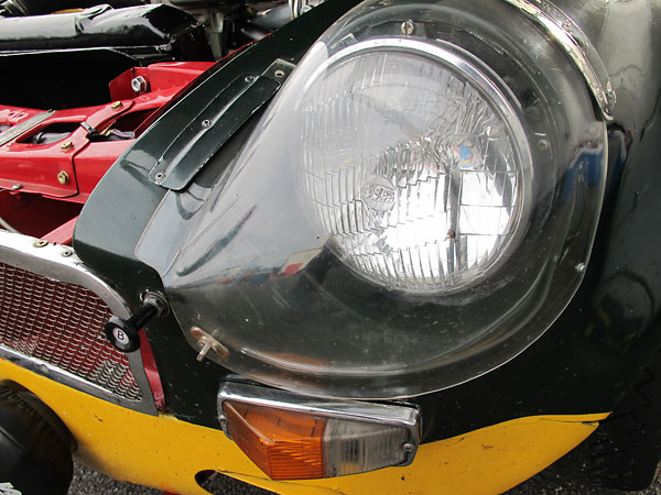 Lucas sealed beam headlights under molded perspex fairings.