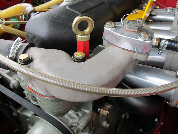 Thermostat housing. Normally, a pressure relief radiator filler cap would be installed at right.
