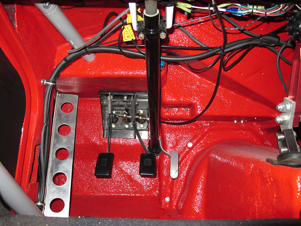 Original Daimler brake pedal assembly has been modified to accommodate dual master cylinders.