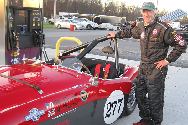 Mike Bartell standing next to his 1956 Austin Healey 100M racecar.