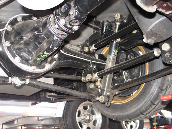 Rather than rigidly couple the springs to the axle at the spring perches, four adjustable radius rods do the job
