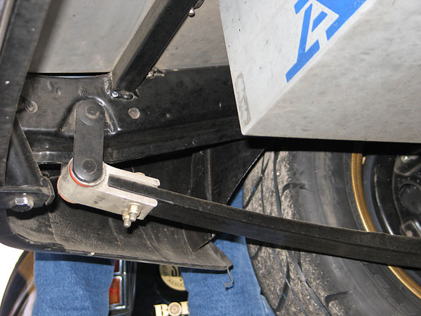 Close-up view of the rearward attachment point of a fiberglass leaf spring.