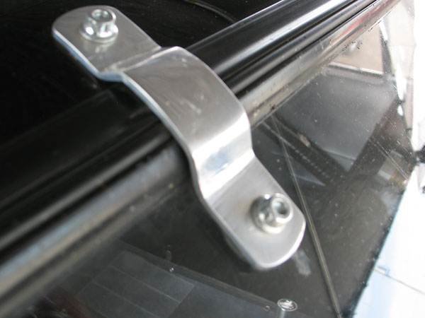 Aluminum windshield hold-downs supplement the rubber grommet.