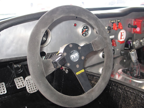 Momo suede-covered steering wheel. Pushbutton on the left spoke is for the two-way radio's microphone.