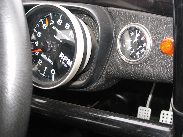 AutoMeter SportComp Monster tachometer (0-10000rpm) and Stewart Warner coolant temperature gauge (100-280F).