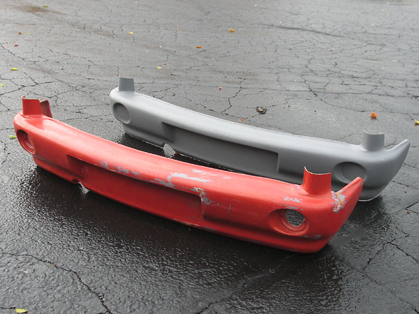 An original (slightly damaged) MG RV8 rear bumper, and a fiberglass replica made from it.