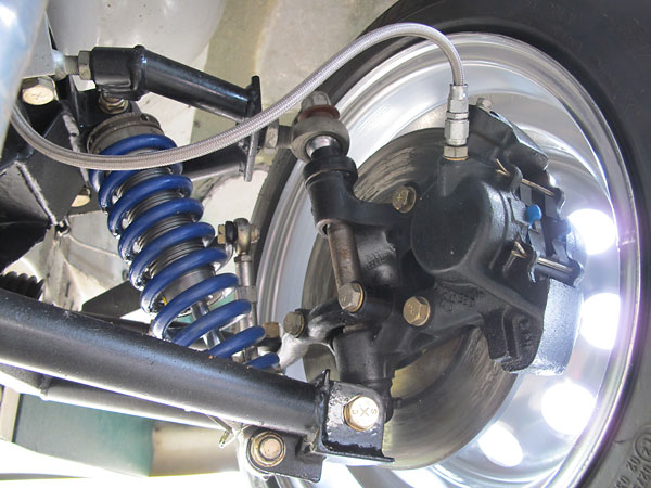 Stock MGB (Lockheed) iron brake calipers and rotors (solid). Hawk blue brake pads.