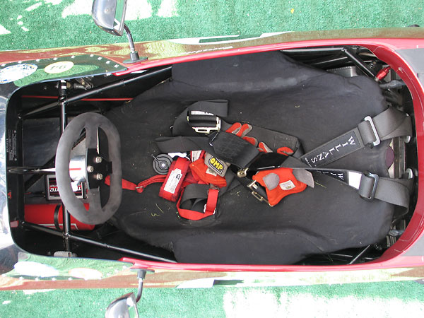 Custom-fitted drivers seat. Willans six-point cam-lock safety harness.