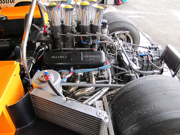 A large NACA duct on the passenger side of the body directs air into a single engine oil cooler.