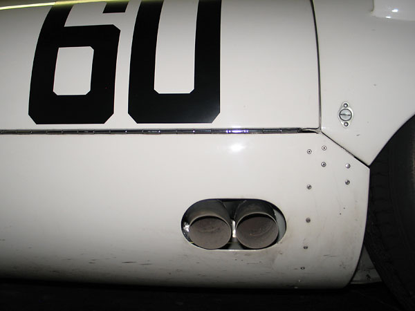 The exhaust exits below the passenger-side door.