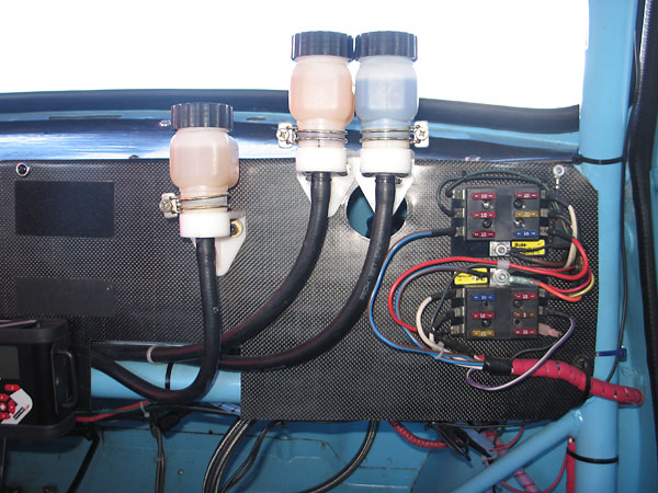 Remote brake and clutch master cylinder reservoirs. Buss six-fuse terminal blocks.