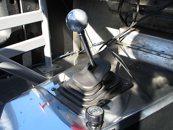 An adjustable brake proportioning valve remains where it was installed for SCCA racing.